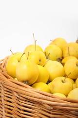 yellow apples in a wicker basket