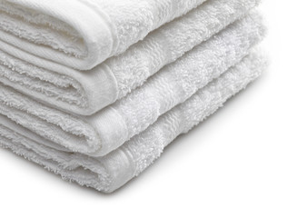 Fototapeta na wymiar Stack of white hotel towels on a white background