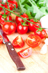 fresh tomatoes, rucola, garlic and old knife