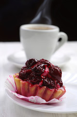 Cake with cherry and cup of coffee