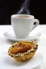 Cake with nuts and cup of coffee