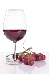 glass of red wine and grape isolated on white background
