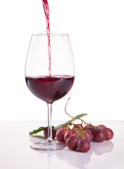 glass of red wine and grape isolated on white background