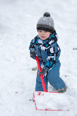 Fototapeta na wymiar Adorable toddler boy happy about snow in winter