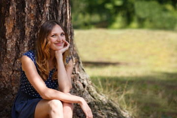 Portrait of young beautiful woman in summer forest