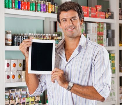 Man Showing Tablet In Grocery Store