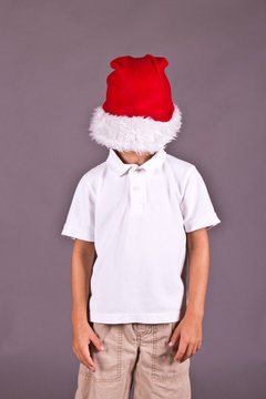 Boy Being Silly With Santa Hat During Christmas