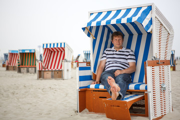 Young happy man on the beach of St.Peter Ording, North Sea,