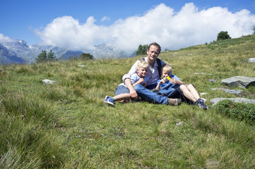 Naklejka na ściany i meble Father and Sons in an alpine meadow