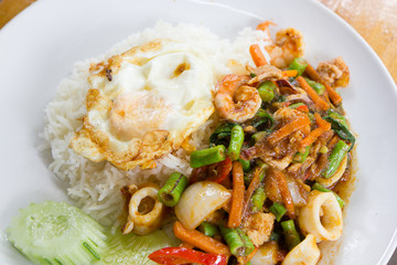 Spicy seafood fried with fried egg and rice