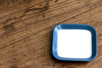 empty square white and blue color dish on wood