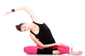 Fototapeta premium beautiful young brunette woman stretching muscles arms isolated