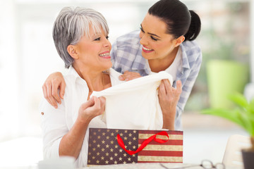 excited middle aged mother looking at her gift