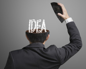 IDEA letter inside businessman head in gray background