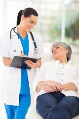 medical doctor consulting senior patient in office