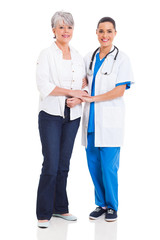 medical doctor standing with senior patient