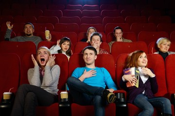 Group of young people watching movie in cinema