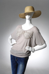 Fashion female clothing in hat on mannequi