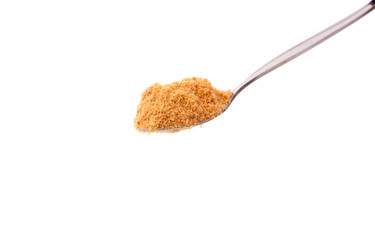 a spoon of brown sugar isolated on white