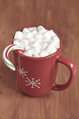 Red mugs with hot chocolate and marshmallows