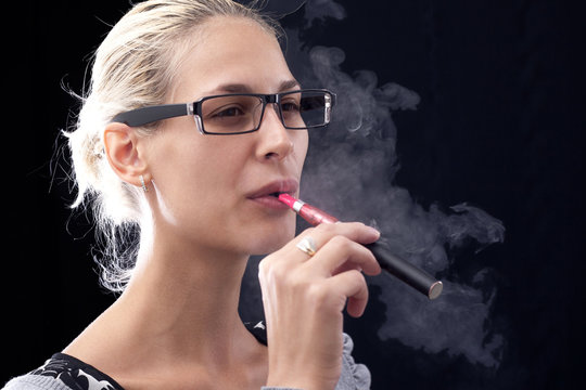 Young woman smoking e-cigarette