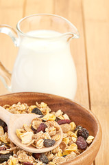 Plate with raw oatmeal on wooden table.