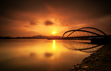 Curvy bridge in silhouette at sunrise in Putrajaya, Malaysia