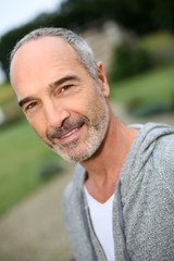 Fototapeta premium Cheerful casual senior man in countryside