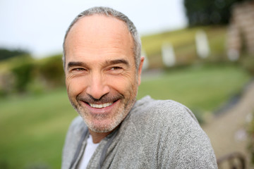 Fototapeta premium Cheerful casual senior man in countryside