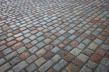 Old wet stone paved avenue street road