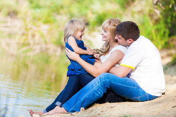 Fototapeta premium happy young family spending time outdoor on a lake