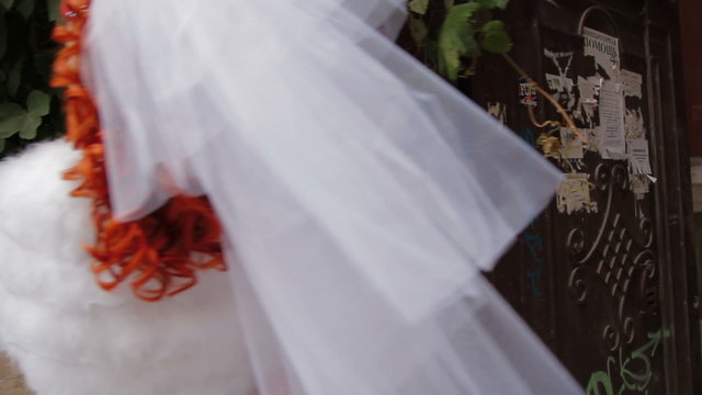 Bride posing for cameras with a wedding bouquet