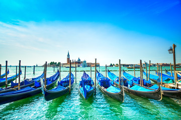 Naklejka premium Venice, gondolas or gondole and church on background. Italy