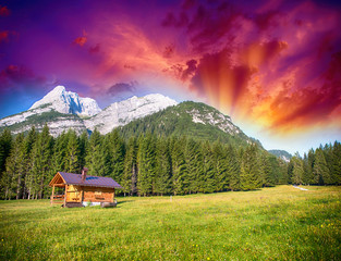 Alpin Hut with meadows, trees and mountain peaks - Summer colors