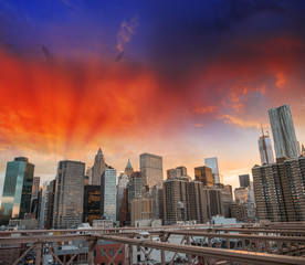 New York cityscape from Brooklyn Bridge. Skyscrapers at sunset