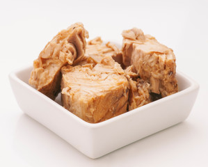 marinated chunks of tuna isolated on porcelain