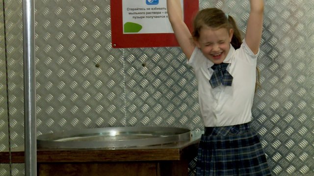 Little girl makes a big soap bubble. Moscow Museum of Science