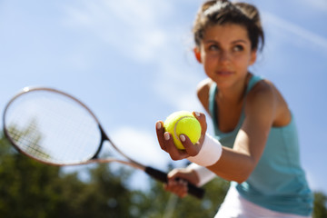 Girl playing tennis on the court