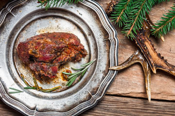 Roasted venison served on an old metal plate