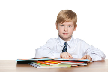 Boy is reading at the desk