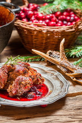 Venison with cranberry sauce in the forester