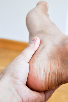 man having heel or ankle pain