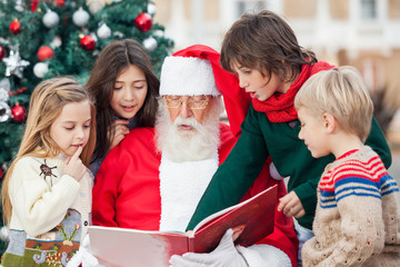 Santa Claus And Children Reading Book