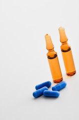 vials or ampules and blue pills