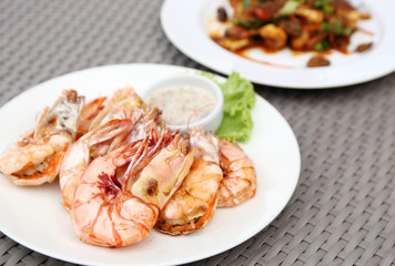 grilled shrimps with seafood sauce on white plate