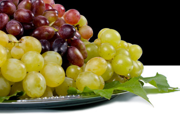 Red and green grapes on a platter