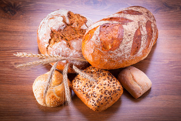 Assortment of fresh bread on wooden table