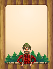 A lumberjack standing in front of the pine trees