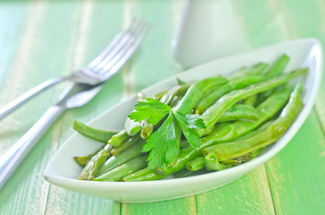 fried beans on white plate