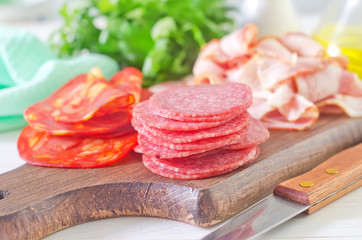 salami,ham and bacon on wooden board